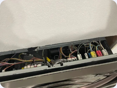 Range control area with its rear panel open and wiring connections visible.