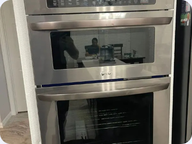Stainless steel LG double wall oven installed in a kitchen cabinet opening.