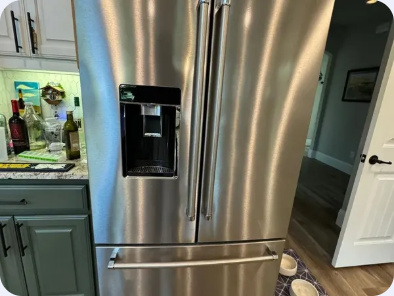 Stainless steel French-door refrigerator with a through-door dispenser and lower freezer drawers.