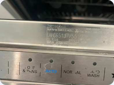 Thermador dishwasher identification label and upper-edge wash-cycle controls.