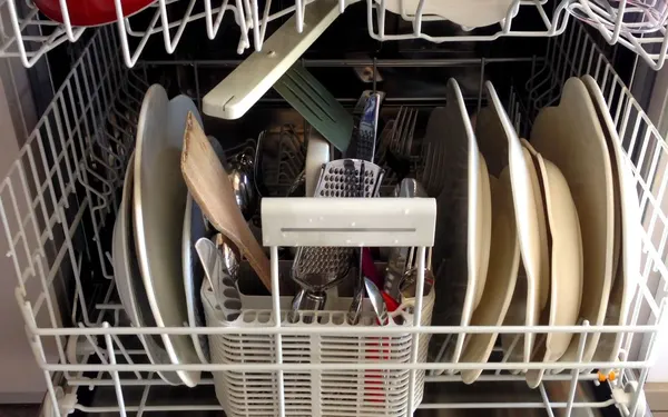 Dishwasher Repair in Springfield MO | Service Brothers Open dishwasher rack loaded with dishes and utensils