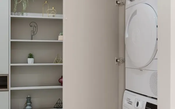 Dryer Repair in Springfield MO | Service Brothers White clothes dryer above a washer in a laundry cabinet