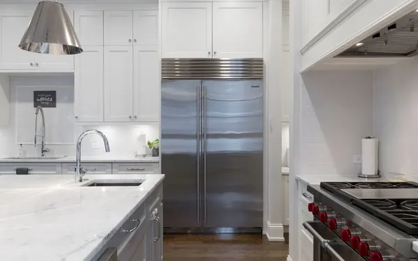 Refrigerator Repair in Springfield MO | Service Brothers Stainless steel built-in refrigerator in a white kitchen