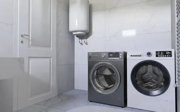 Washer Repair in Springfield MO | Service Brothers Front-loading washing machine beside another laundry appliance