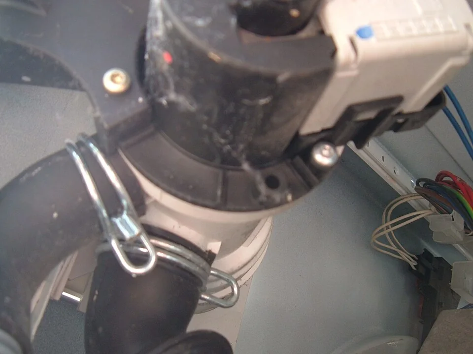 Washing-machine drain pump and connected hoses inside the cabinet