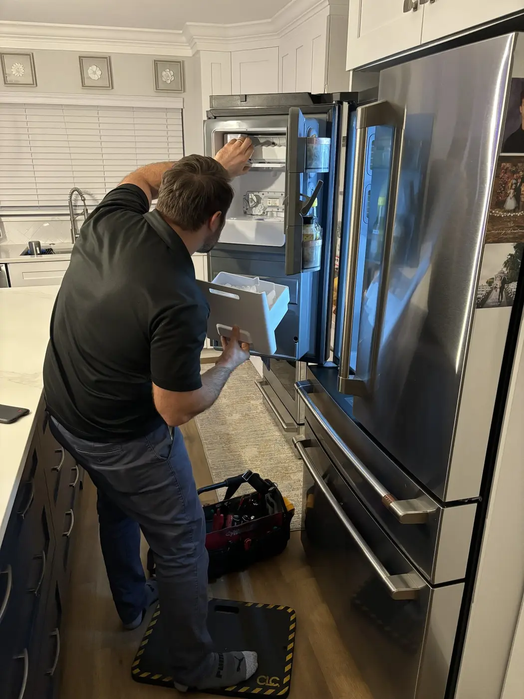 Ice-maker compartment service | Service Brothers Technician working at a refrigerator ice-maker compartment